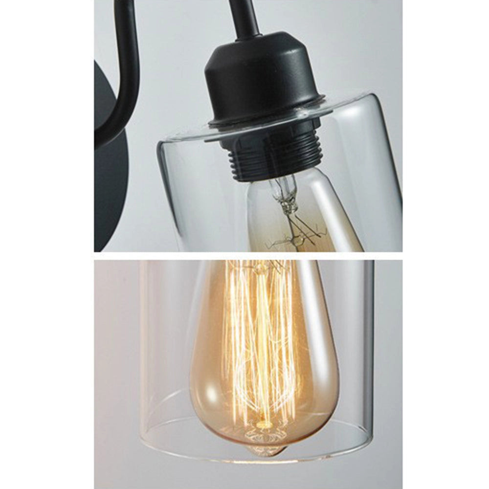 Vintage Edison Bulb Wall Sconce featuring a black metal frame with a clear glass shade, showcasing a classic design with exposed bulb styling against a wooden backdrop.