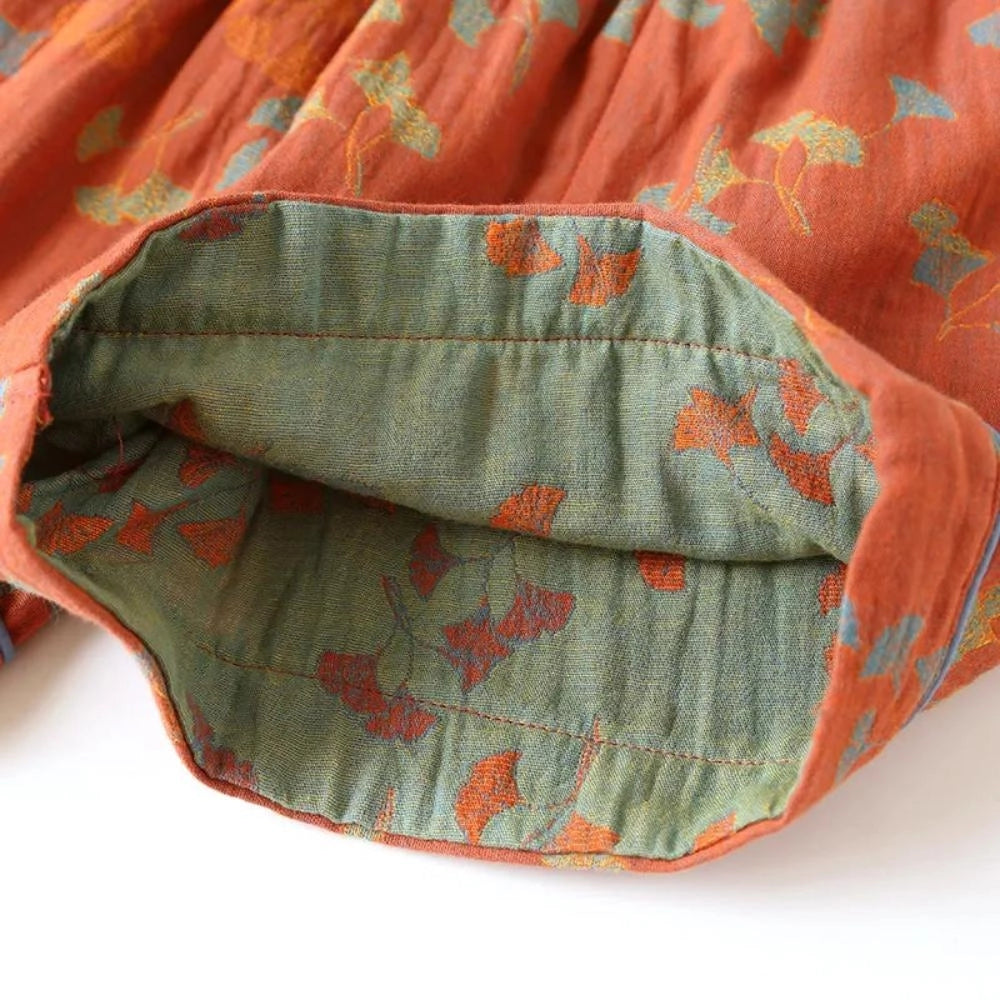 Vintage floral bohemian midi skirt in lightweight cotton with an elastic waist, featuring a brown and carmine pattern.