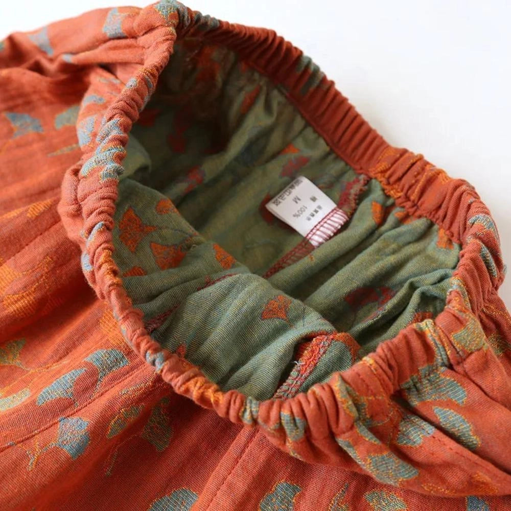 Vintage floral bohemian midi skirt in lightweight cotton featuring an elastic waist with a brown and orange plaid pattern.