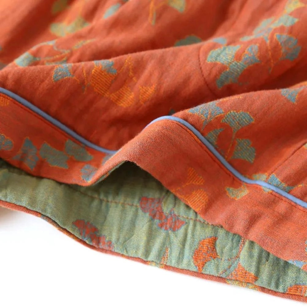 Vintage floral bohemian midi skirt made of lightweight cotton with an elastic waist, featuring an orange and peach floral pattern.