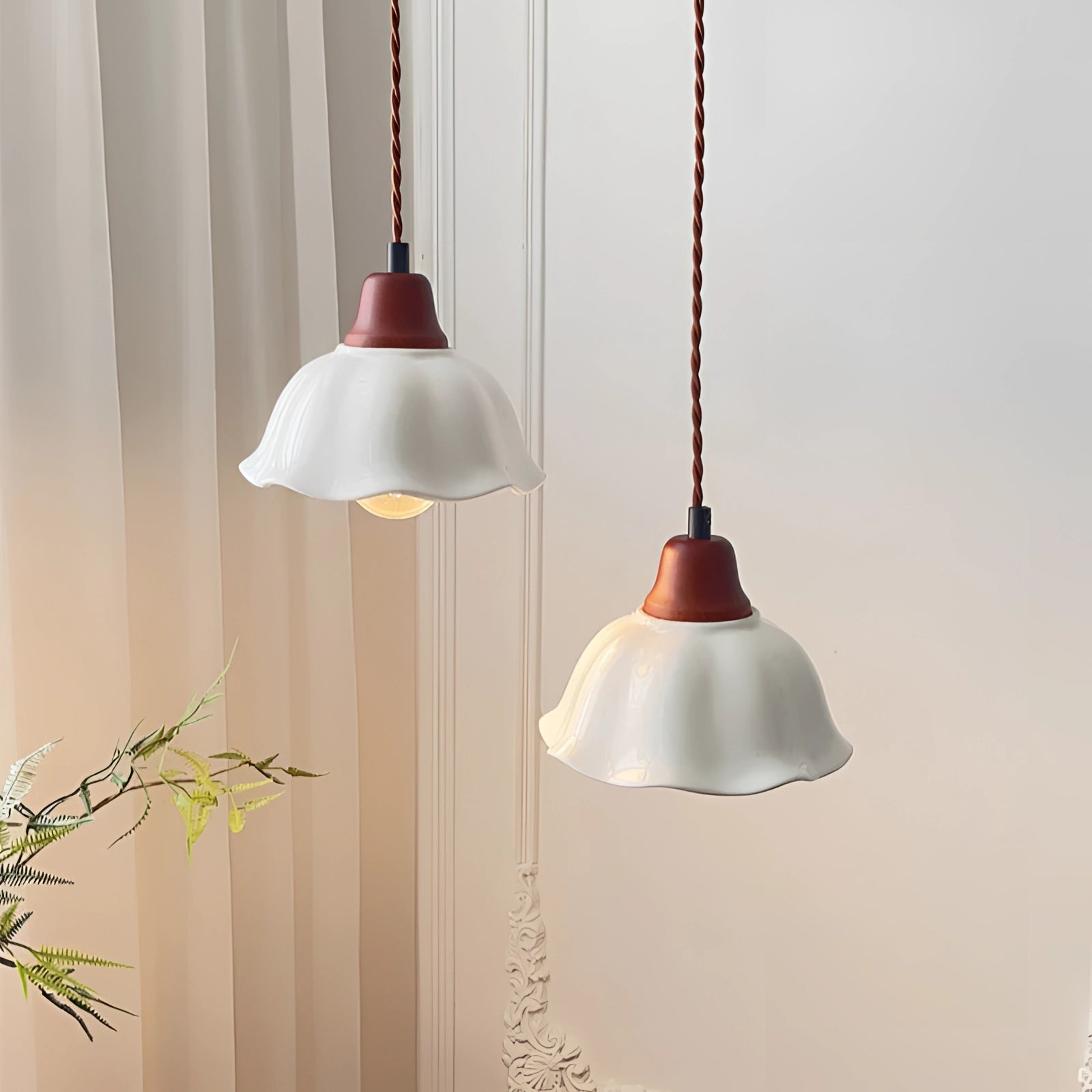 Vintage floral glass pendant light with frosted design, hanging from the ceiling, illuminating the area with a soft glow.