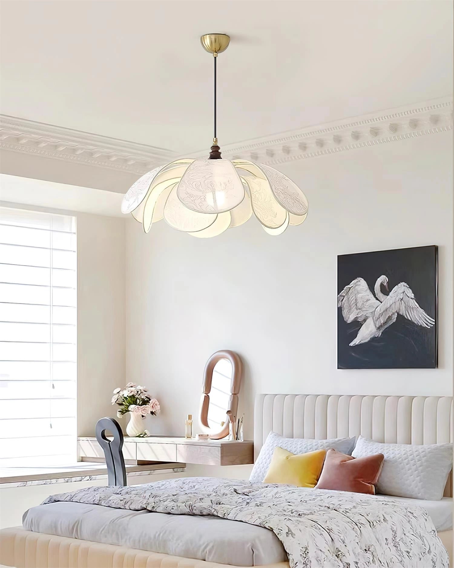 Vintage floral pendant light with etched glass lampshade hanging in a stylishly decorated living room with grey couch and wooden furniture.