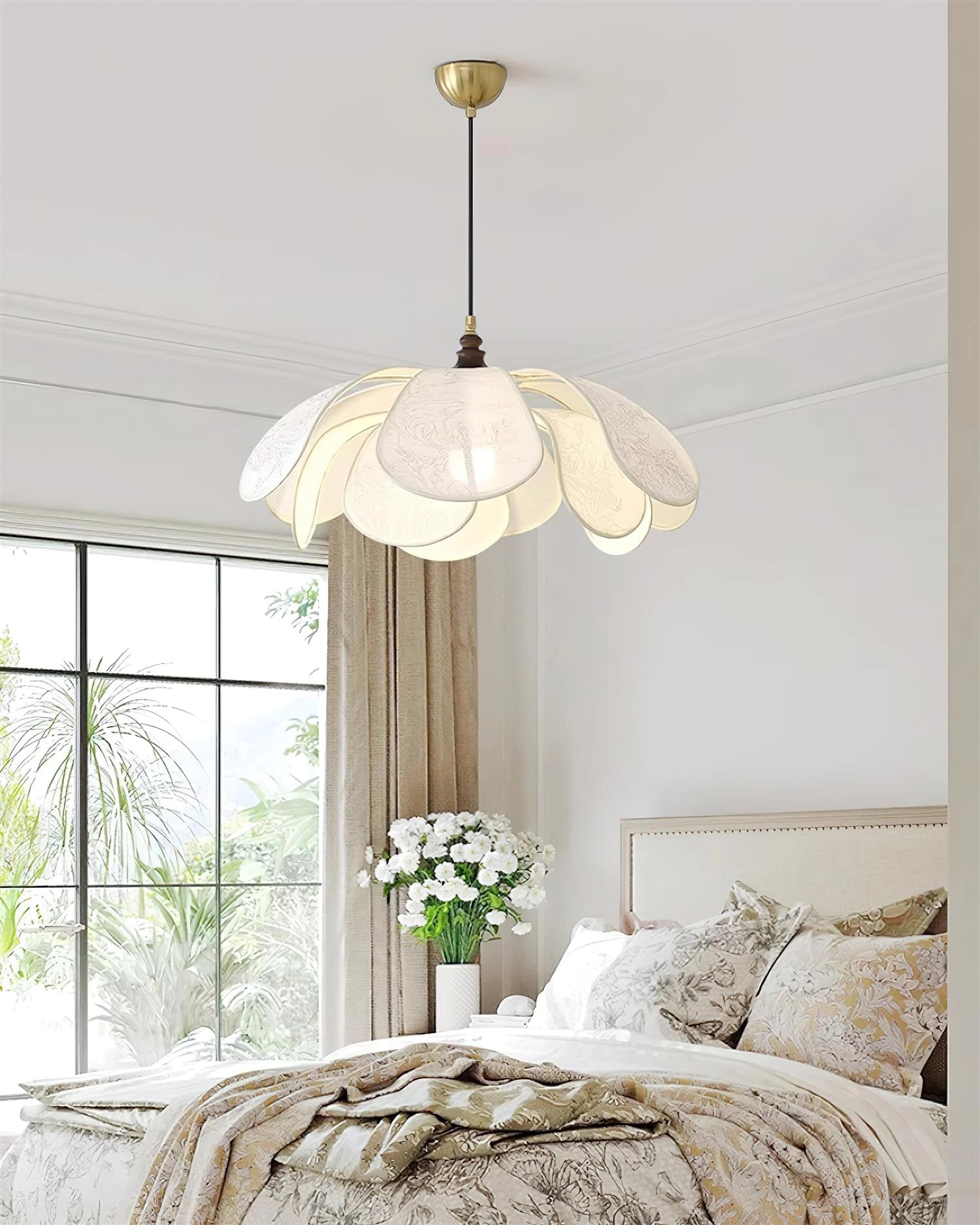 Vintage floral pendant light with etched glass lampshade hanging in a dining room with wooden accents and large windows.