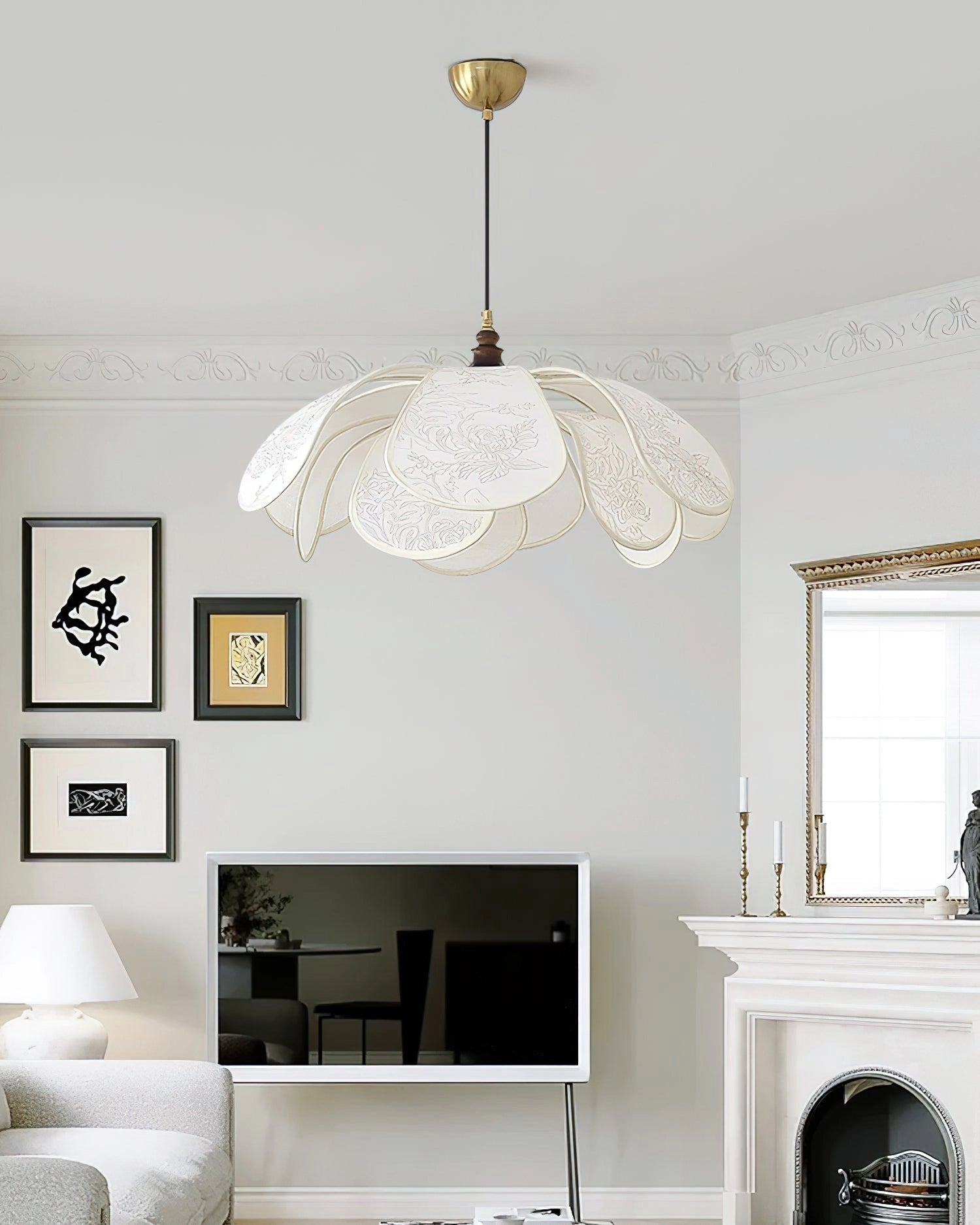 Vintage floral pendant light with etched glass lampshade hanging in a dining room with white walls and wooden furniture.