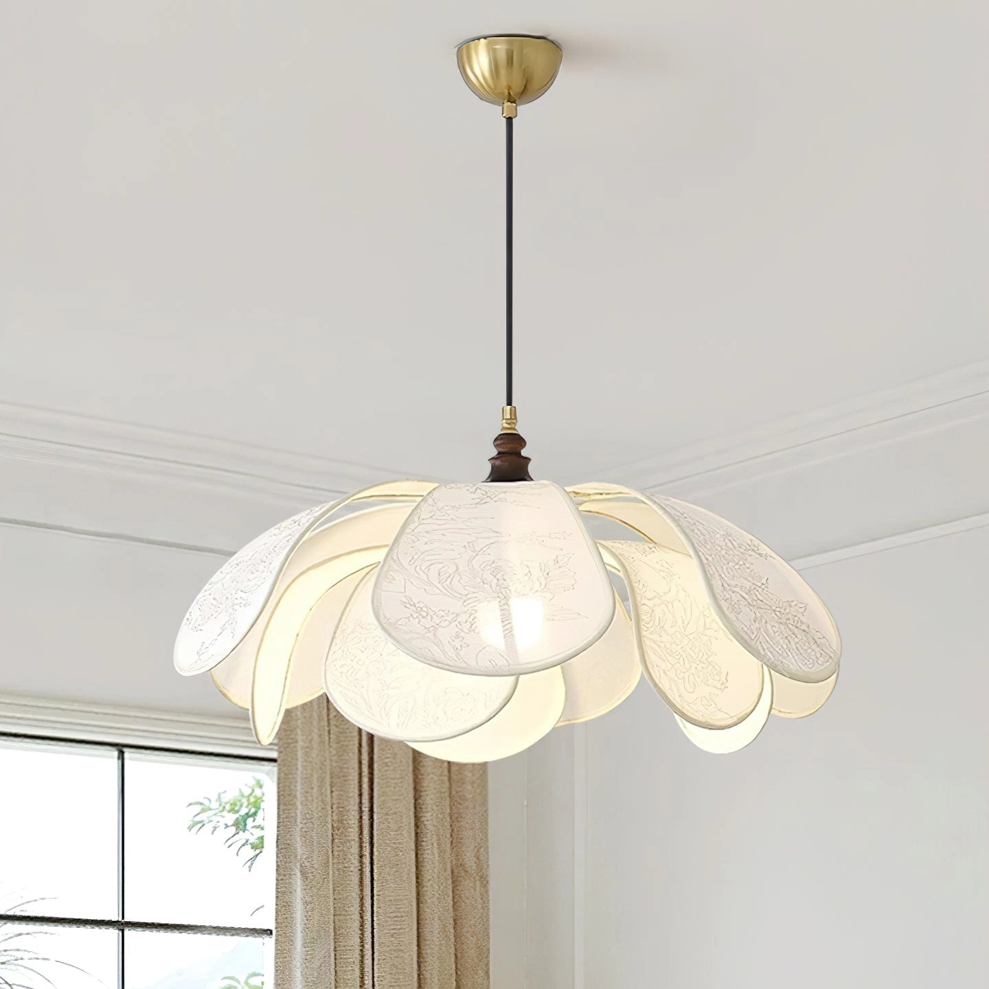Vintage floral pendant light with etched glass lampshade hanging from ceiling above a dining room table, featuring natural wood and twig accents.