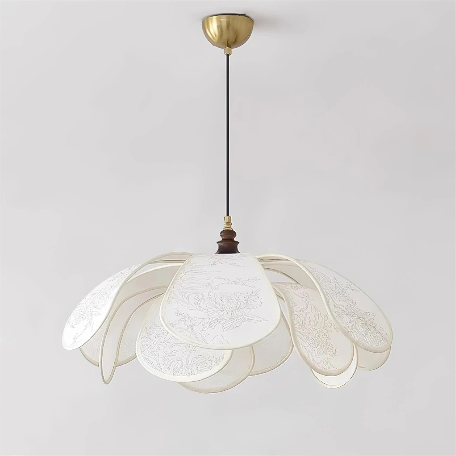 Vintage floral pendant light with etched glass lampshade, featuring intricate feather and wing-like patterns, hanging in a dining room setting.