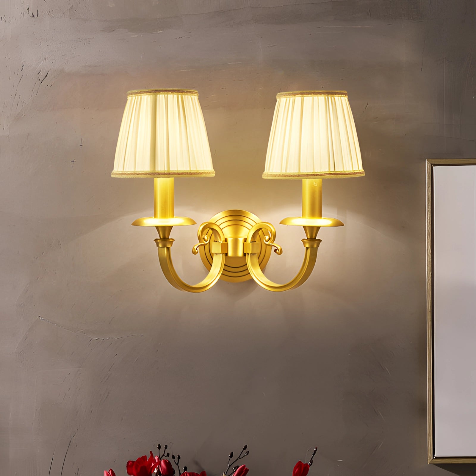 Vintage gold wall sconce with a brass finish, featuring a rectangular design and amber lighting, mounted on a wooden wall in an interior setting.
