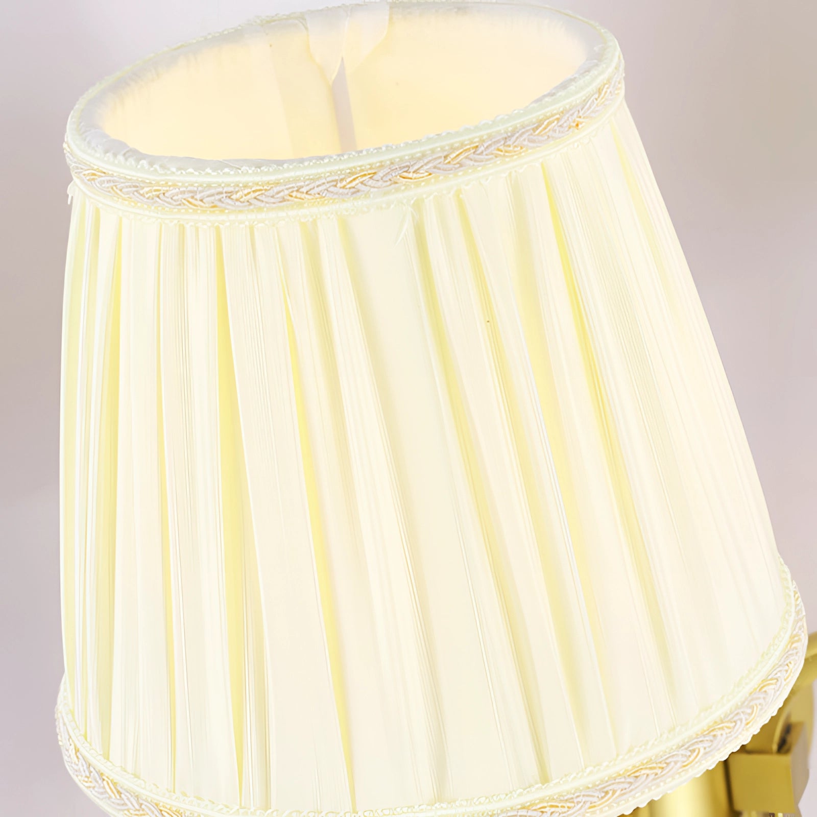 Vintage gold wall sconce with a brass finish, featuring a classic and elegant design suitable for indoor lighting.