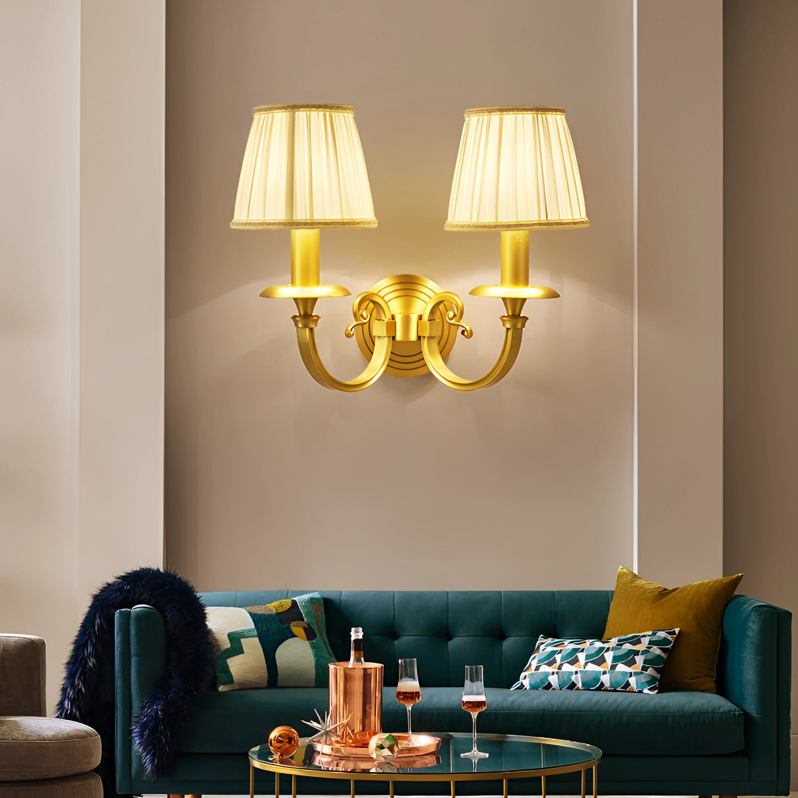 Vintage gold wall sconce made of brass, mounted on a wall, illuminating a room with its warm light.