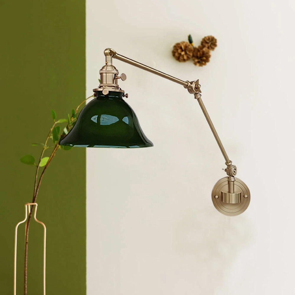 Vintage green enamel wall lamp with an adjustable brass arm, featuring a classic design suitable for both modern and traditional interiors. The lamp adds a touch of elegance and artistic flair to any room.