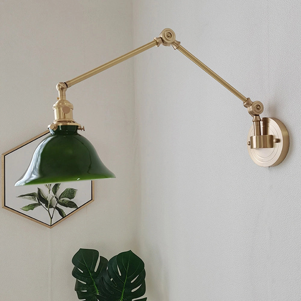 Vintage green enamel wall lamp featuring a brass arm, showcasing a classic design with metal accents, and an elegant light fixture that adds a touch of retro charm.