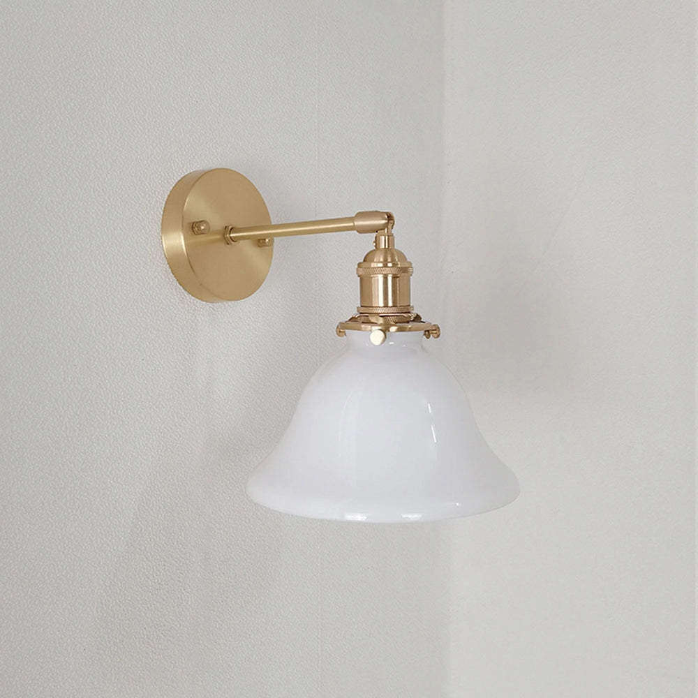 Vintage green enamel wall lamp with brass arm, featuring a white shade and a reflective metallic finish, designed to mount on a wall.