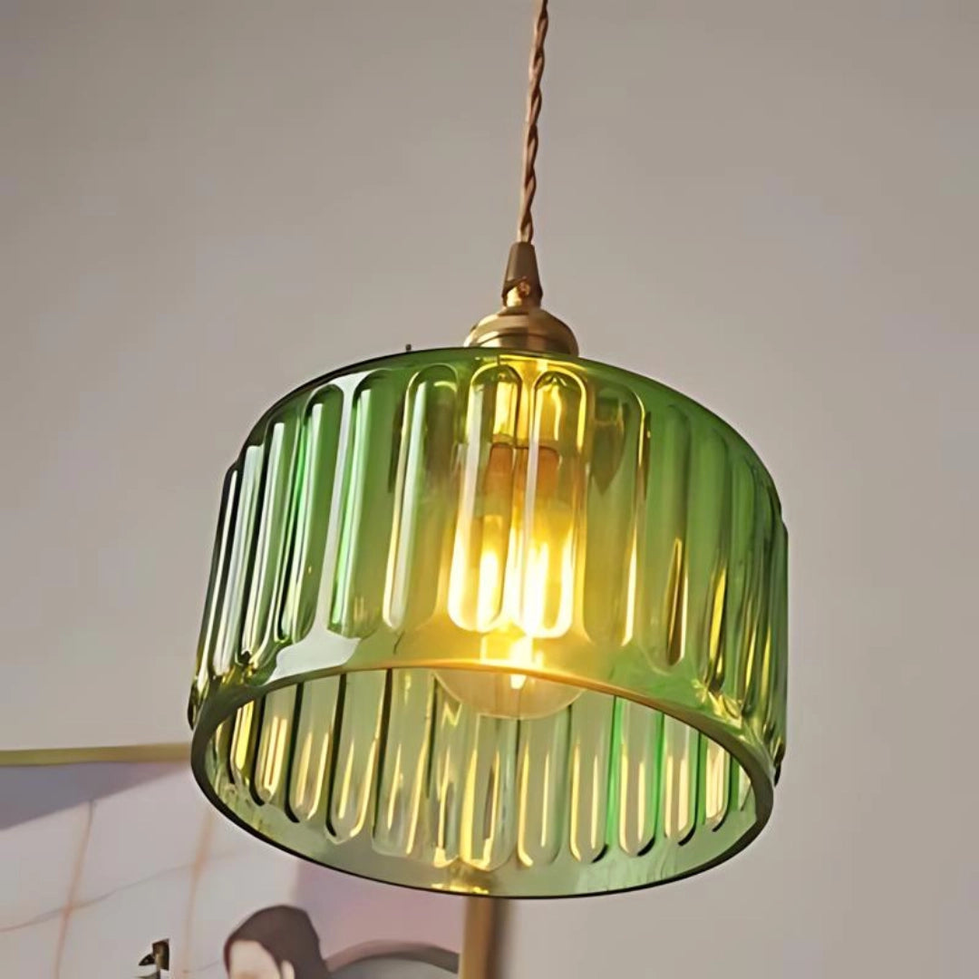 Vintage green glass pendant light with a ribbed oval-shaped glass shade and antique brass fittings, designed as a single hanging fixture for ceiling installation.