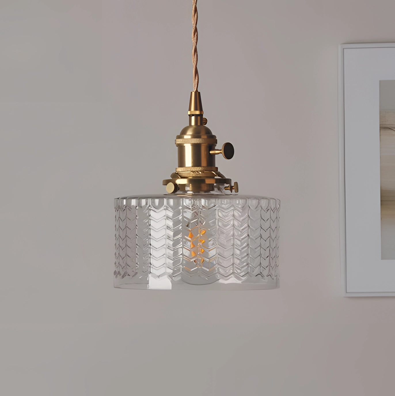 Vintage Industrial Glass Pendant Light with Green Shade and Brass Fittings hanging from ceiling.
