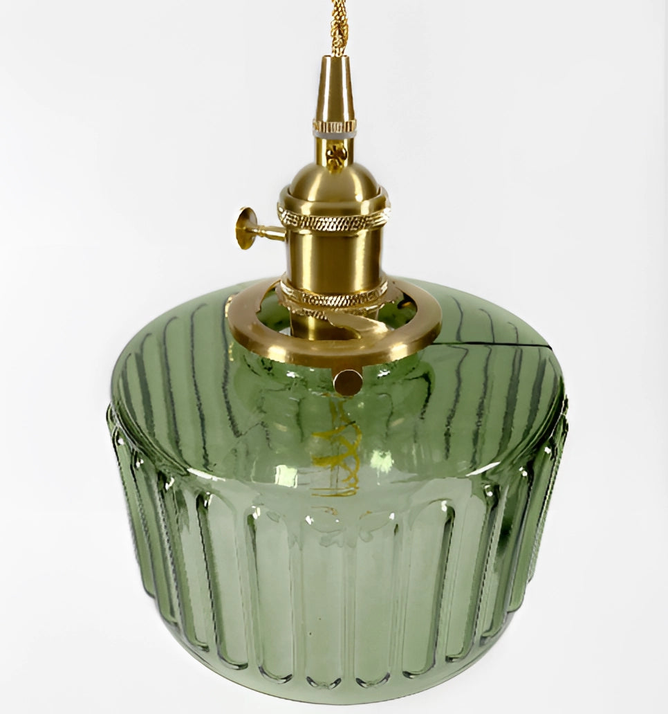 Vintage industrial pendant light with green glass shade and brass fittings, suspended, showcasing a blend of metal and glass materials.
