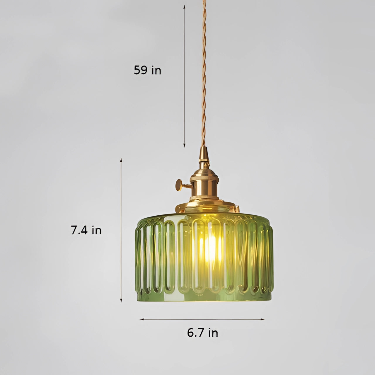 Vintage industrial glass pendant light with green shade and brass fittings hanging from ceiling.