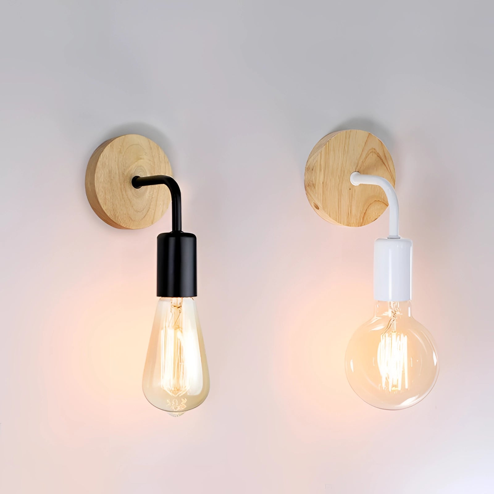 Vintage industrial wall light featuring a wooden base and black metal pipe fixture with a circular sconce design, showcasing a light bulb and exuding a warm, rustic charm.