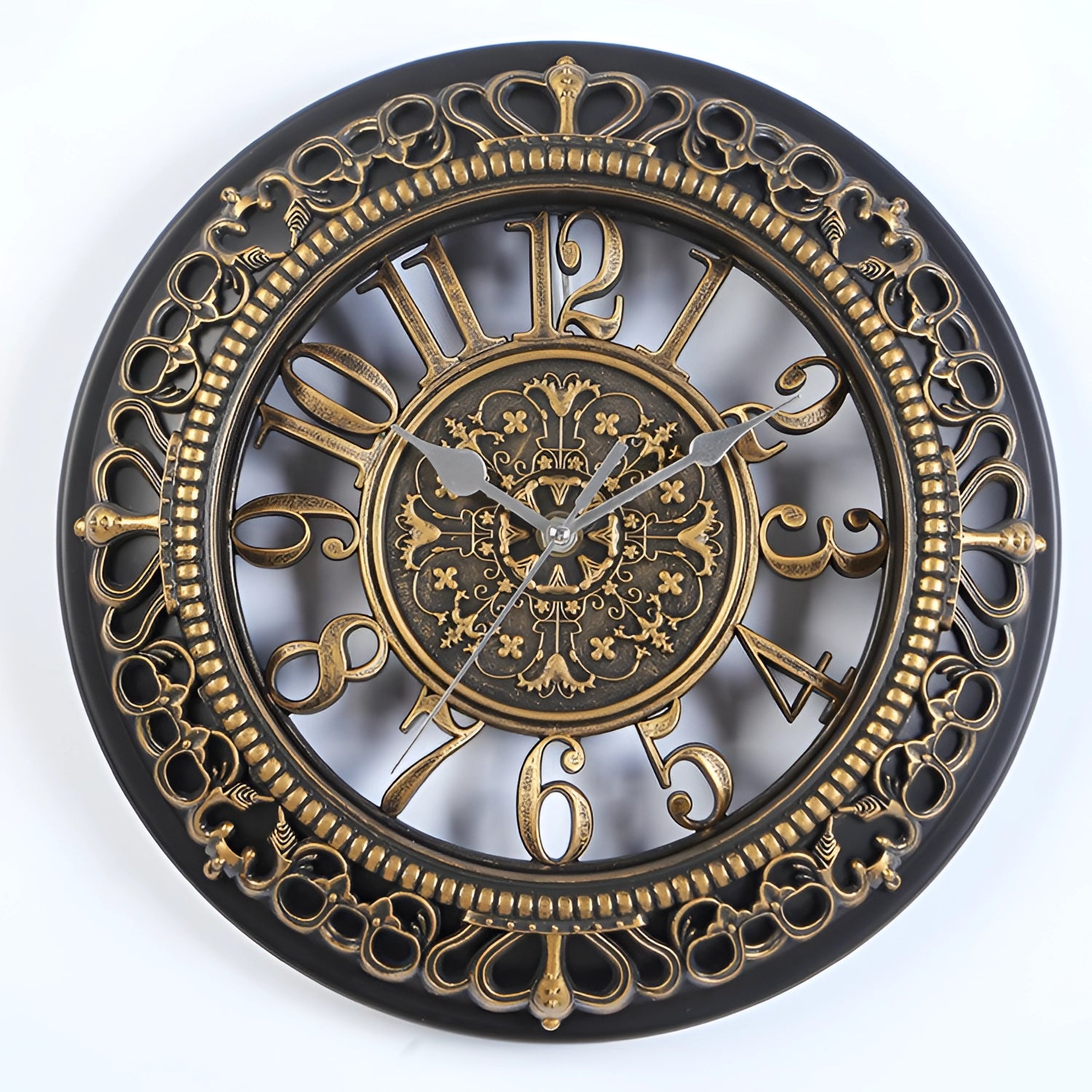 Vintage ornate white wall clock with gold accents featuring Roman numerals, showcasing an artistic circular design with metal elements.