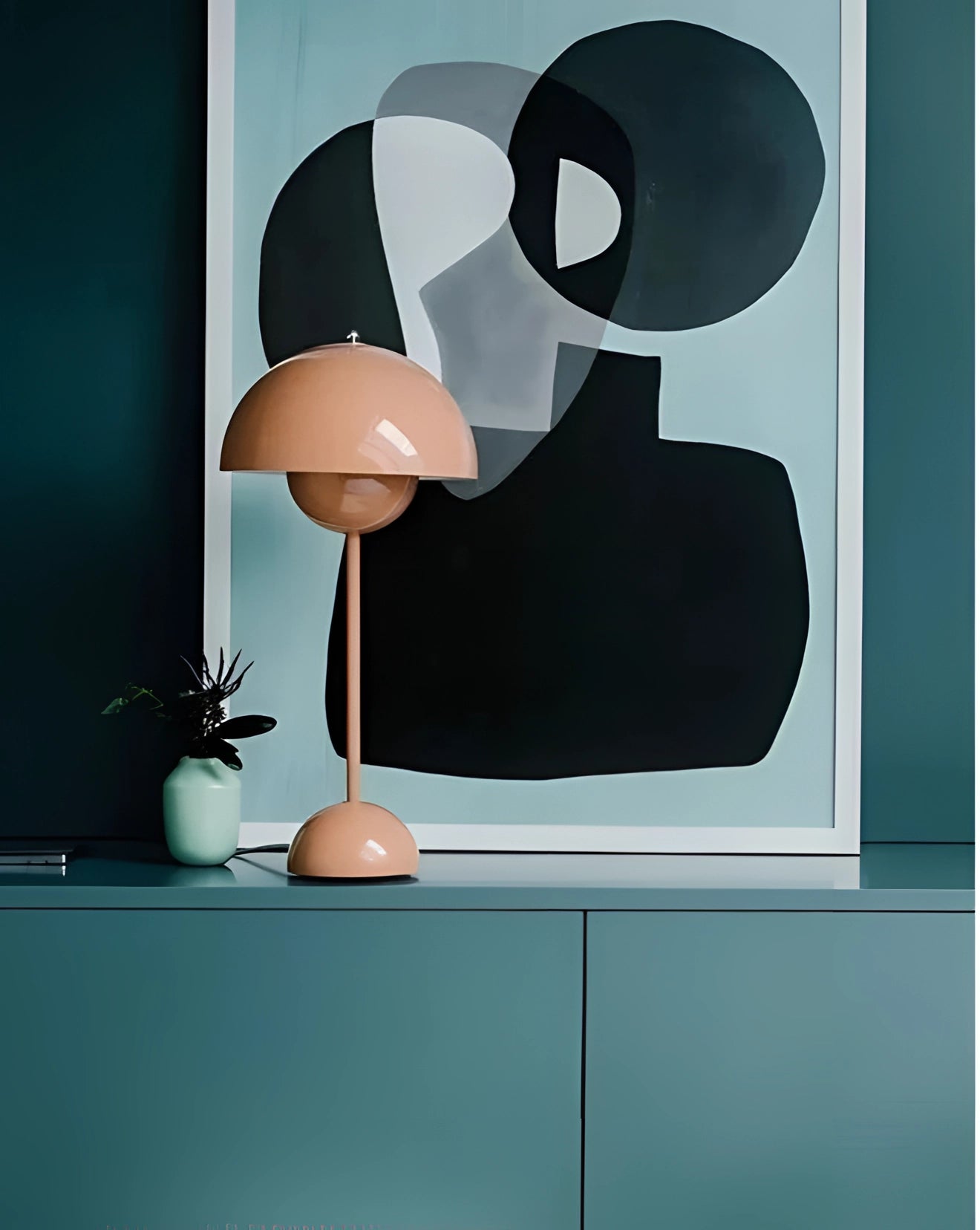 Vintage red desk lamp with a glossy beige-red finish, featuring a retro design with a wooden base, placed beside a houseplant in a room setting.