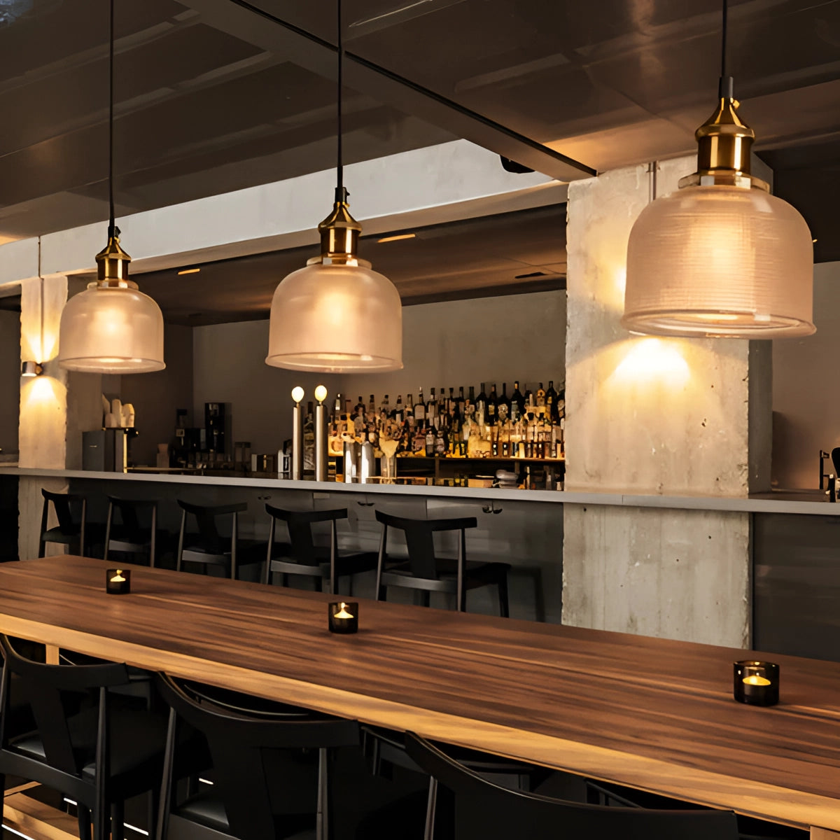 Vintage ribbed glass pendant light with brass detailing, featuring an Edison-compatible bulb, elegantly hanging from the ceiling and illuminating a stylish interior space.