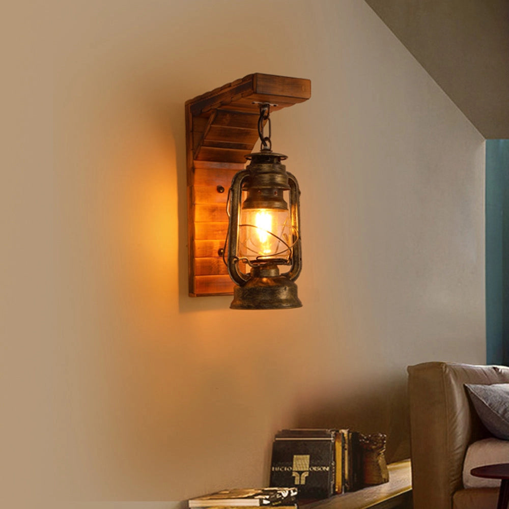 Antique brass oil lantern with a rustic finish, ideal for nautical decor, placed on a wooden surface.