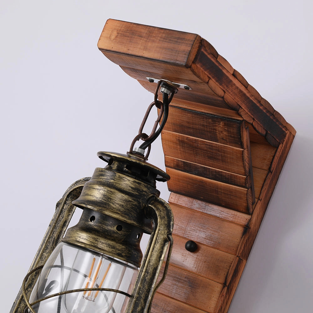 Vintage rustic lantern made of antique brass, designed as an oil lamp for nautical decor, placed on a hardwood surface.