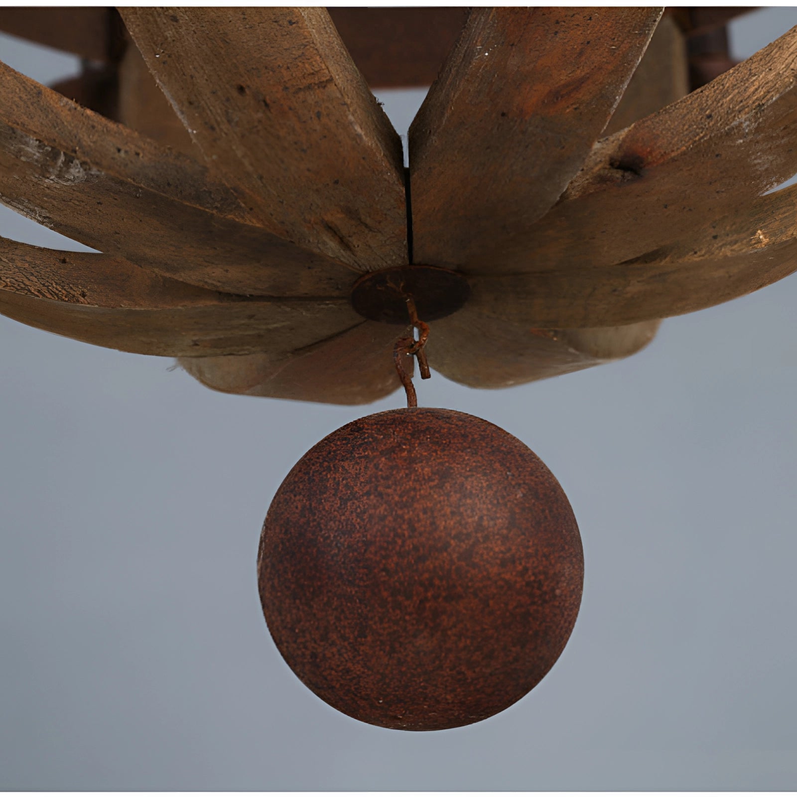 Vintage rustic pendant light featuring a farmhouse wooden and metal chandelier design with an oval shape and twig-like elements, showcasing brown tones and artistic craftsmanship, hanging from the ceiling.