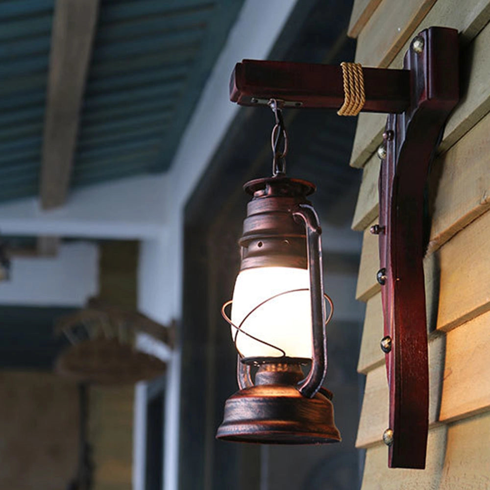 Vintage rustic wall lantern with an antique design featuring a wood and metal frame, amber glass panels, and a gas lamp style, ideal for adding a warm, nostalgic glow to any space.