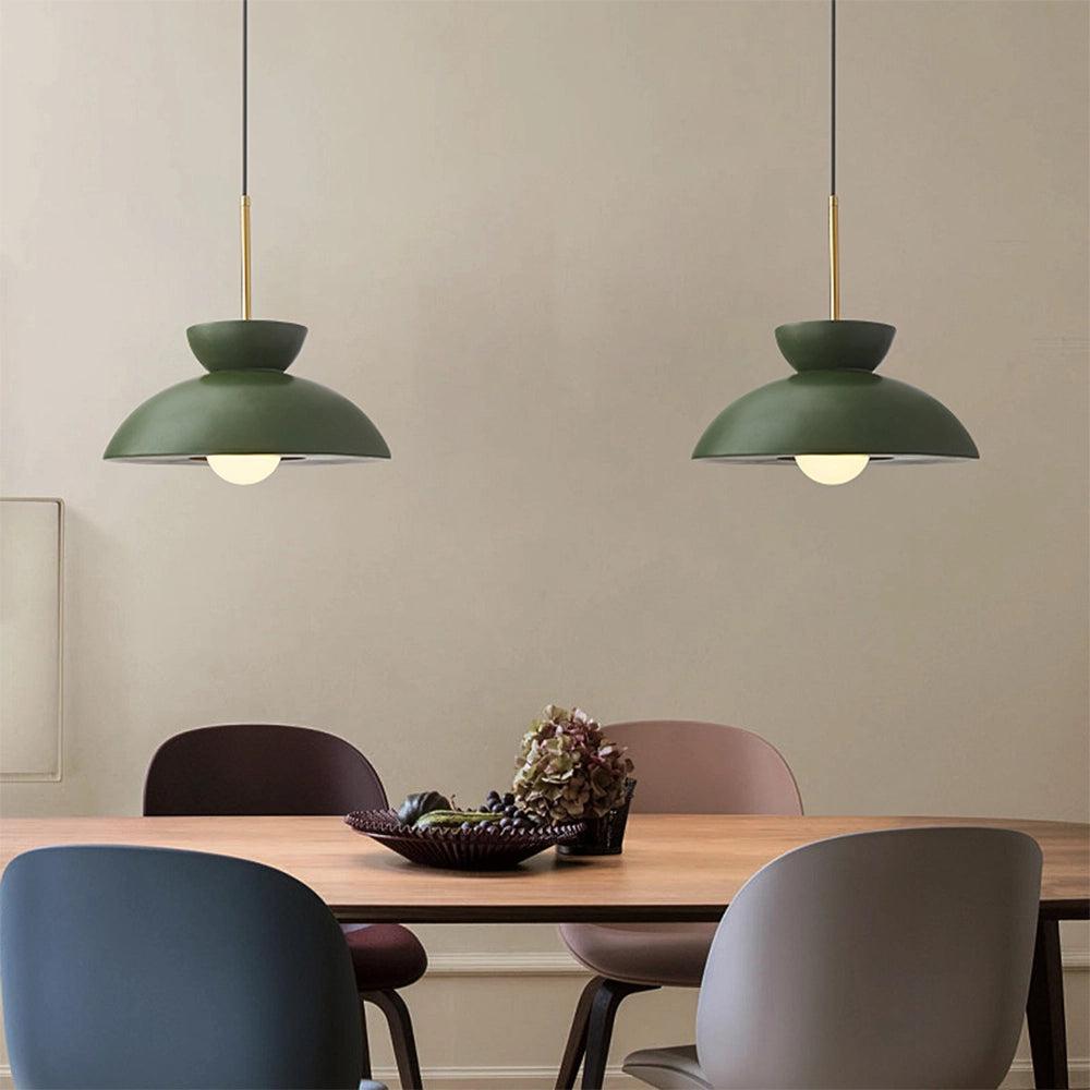 Vintage terra cotta pendant light with mid-century modern design suspended from the ceiling, illuminating a stylish interior space with wooden and white furniture elements.