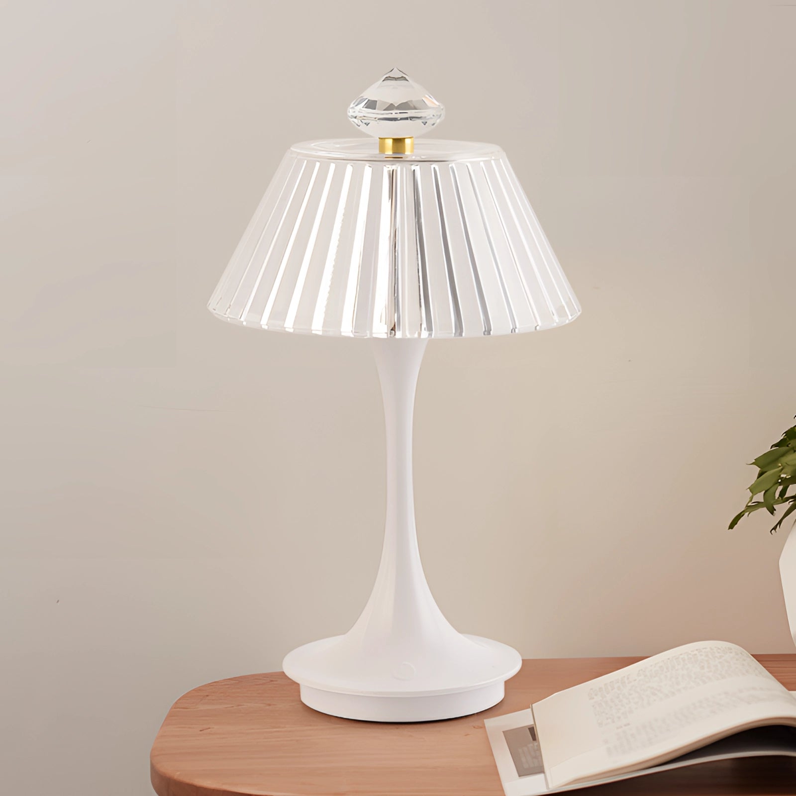 White table lamp featuring a ribbed lampshade and gold accent, set on a wooden table, ideal for modern decor.