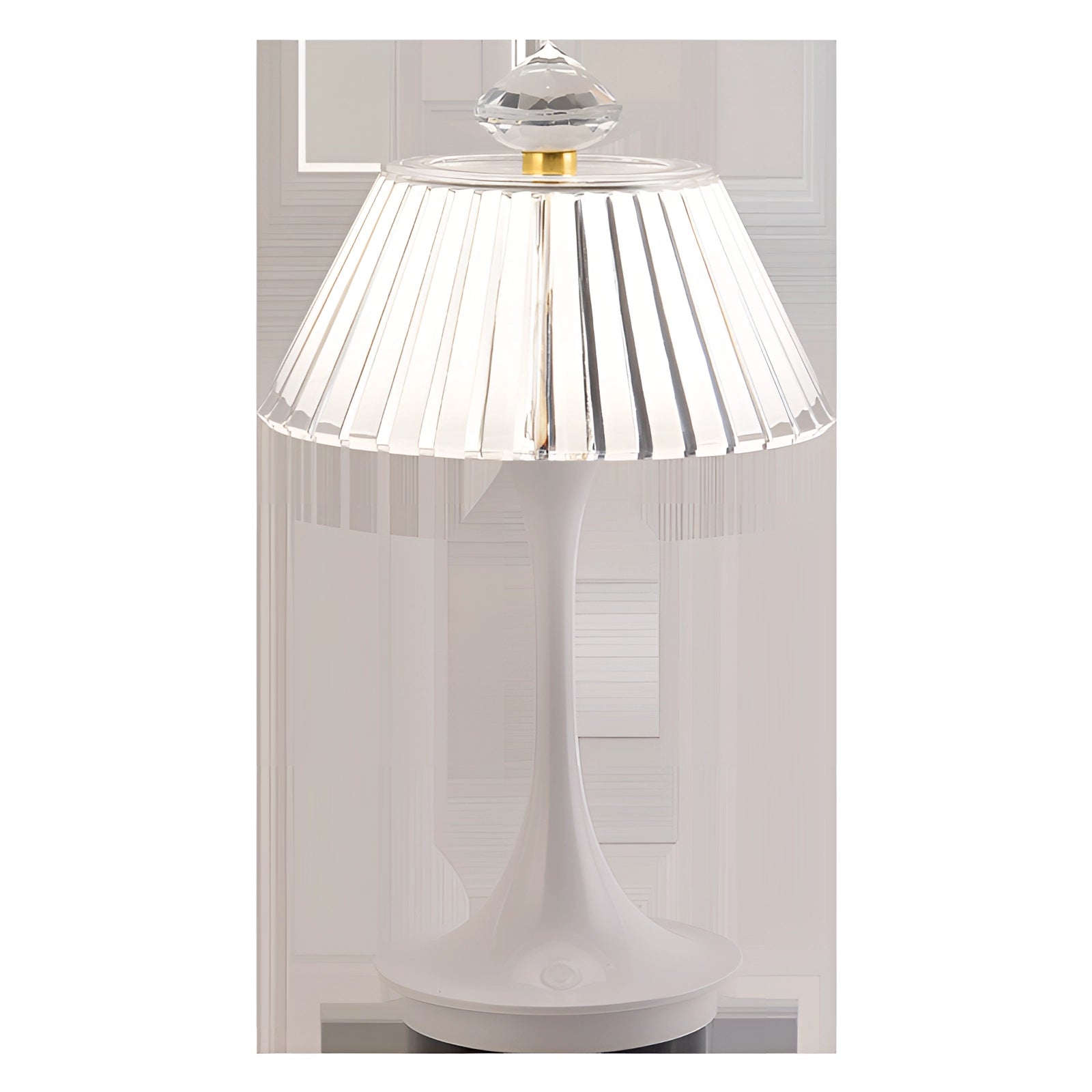 A modern white table lamp featuring a ribbed lampshade and a gold accent, designed for contemporary home decor, placed on a wooden table surface.