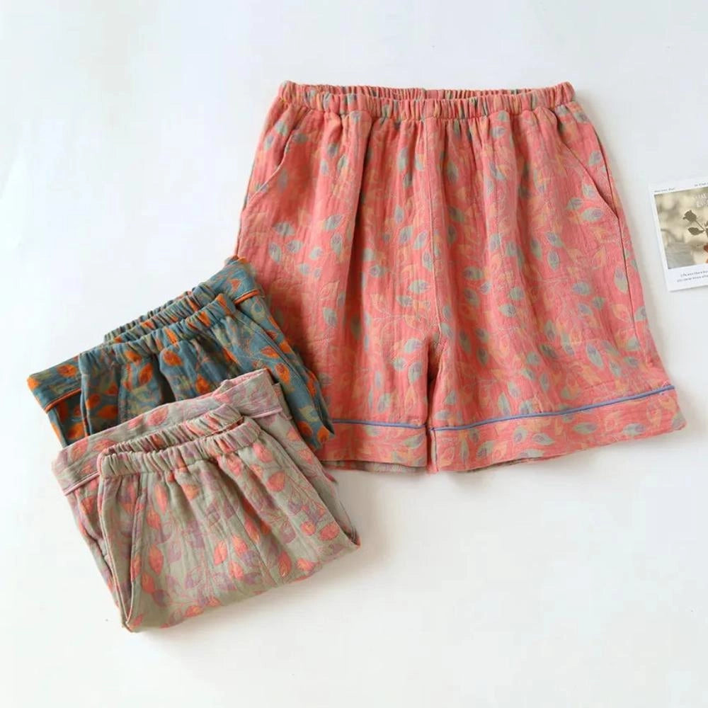 Women's casual shorts with a floral print, lightweight material, and an elastic waistband, featured in a magenta color.