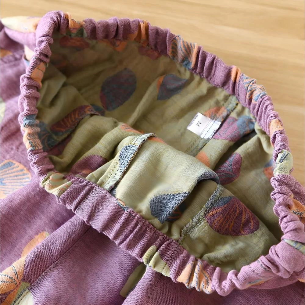 Women's summer shorts featuring a colorful leaf print design, made from breathable fabric with an elastic waist for comfort.