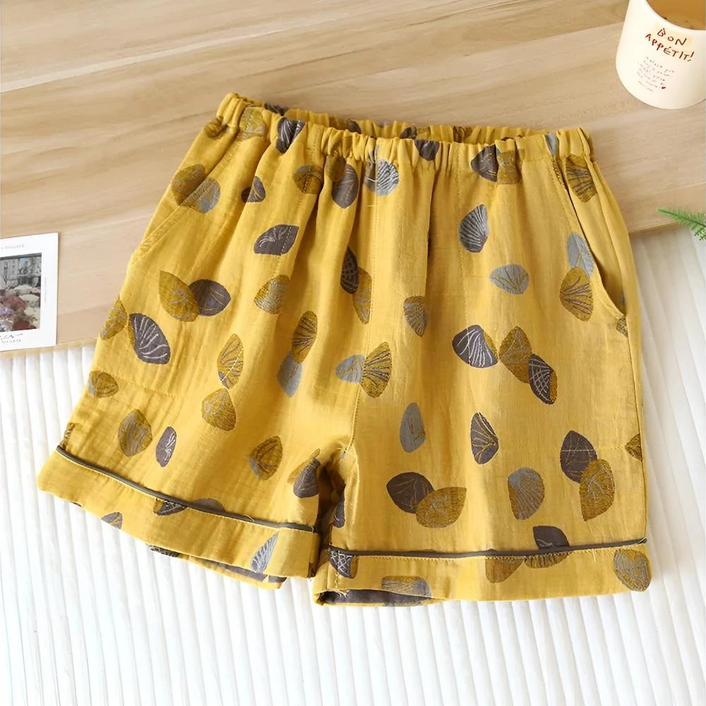 
Yellow women's leaf print elastic waist summer shorts, designed with a colorful and breathable fabric.