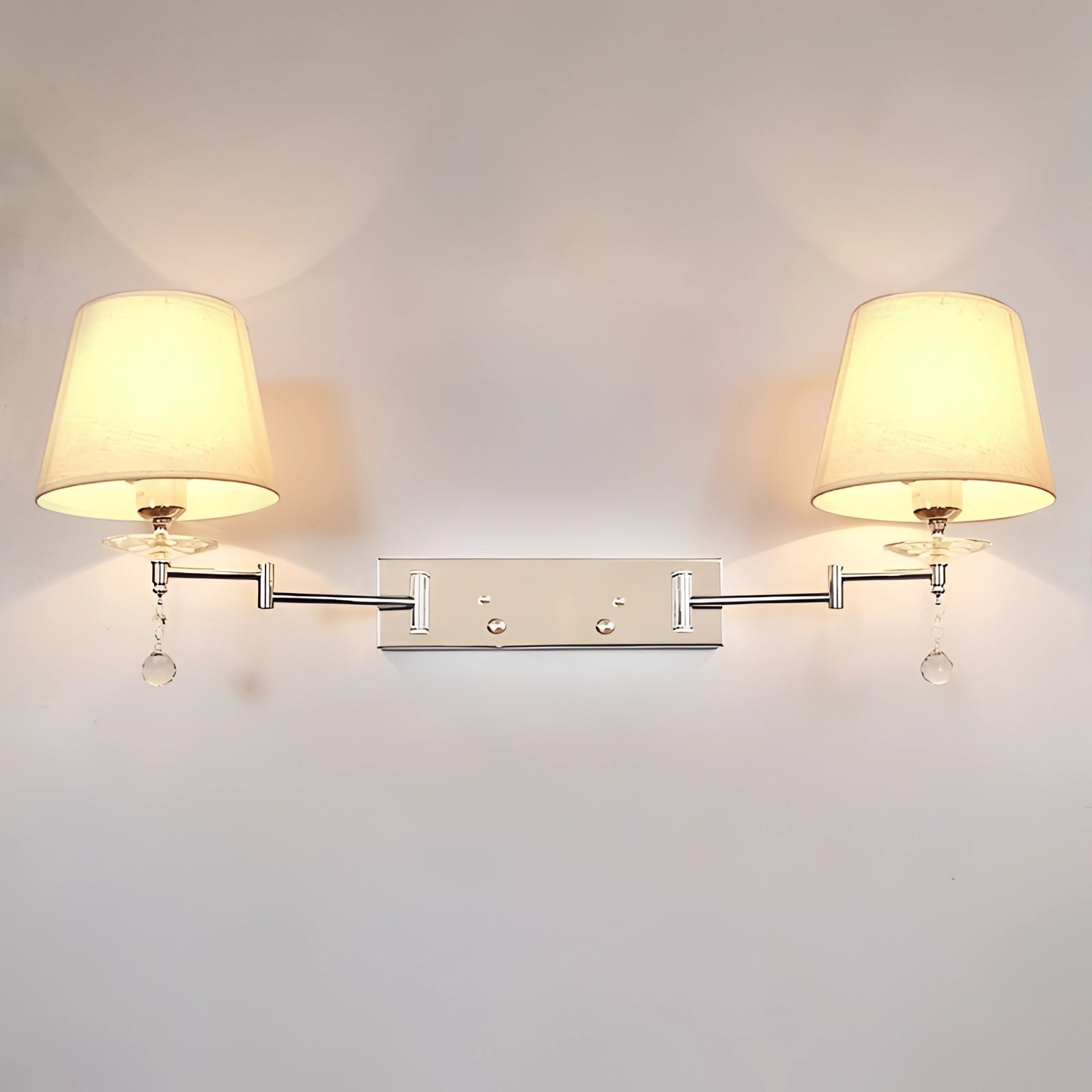 Wood and metal dual wall sconce with beige shades and a crystal pendant, featuring a rectangular design and lighting elements for indoor use.