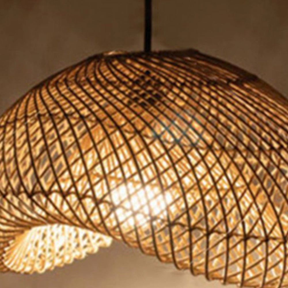 Eco-friendly woven rattan pendant light hanging from the ceiling, featuring a boho design with a circular pattern.