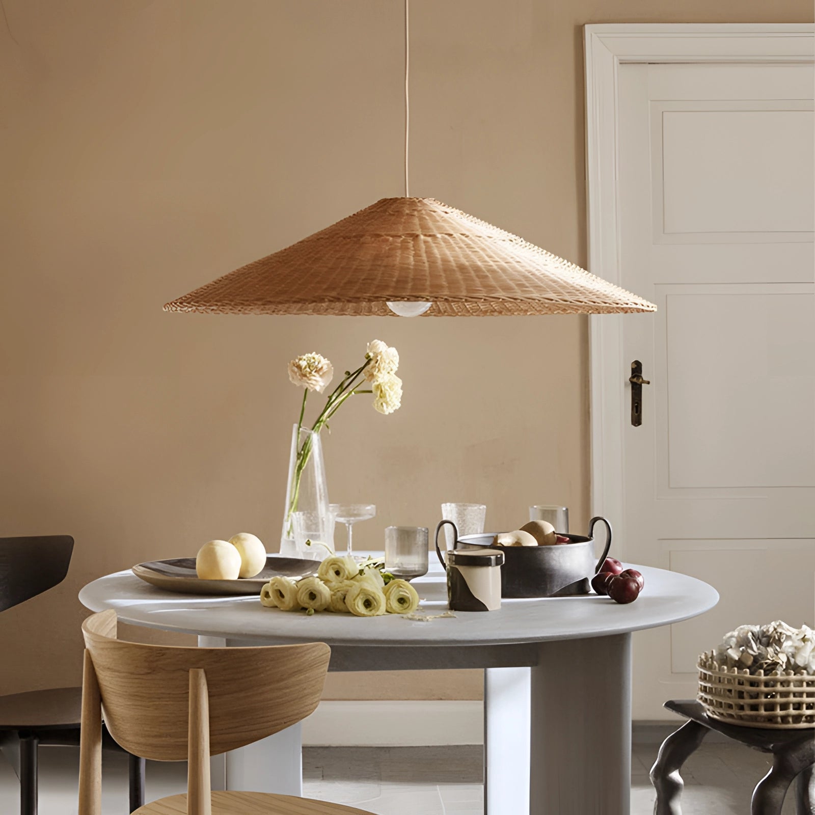 Eco-friendly woven rattan pendant light in a conical shape, natural rattan finish, 60cm diameter, hanging above a grey table in a Scandinavian-style interior.