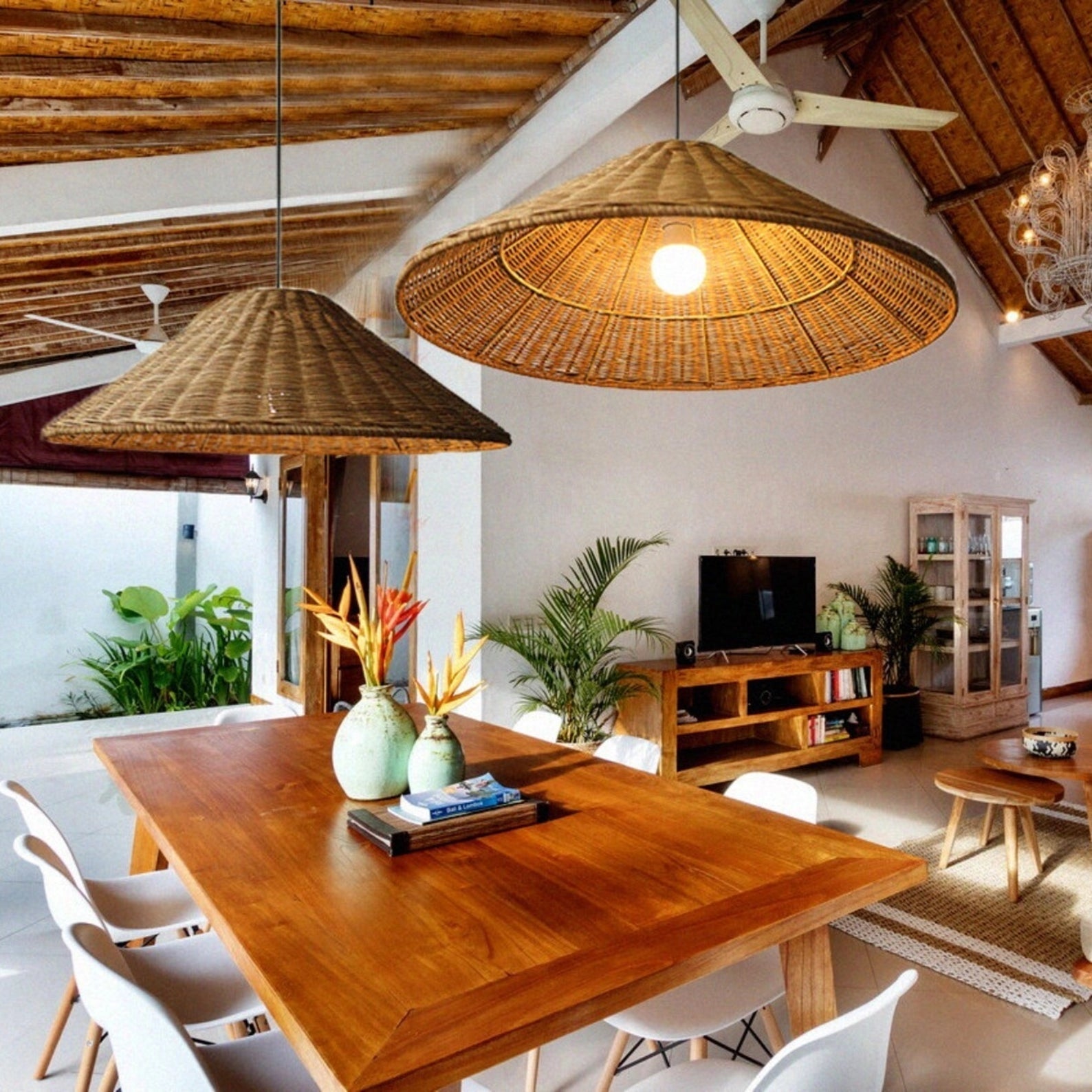 Woven Rattan Pendant Light hanging above a wooden table with chairs, a plant, and Scandinavian interior decor elements.