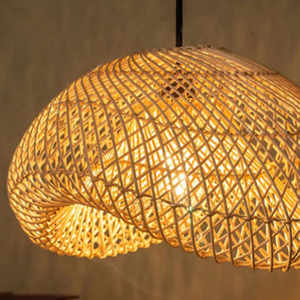Eco-friendly boho woven rattan pendant light with an amber lampshade, hanging from a ceiling, showcasing intricate patterns.