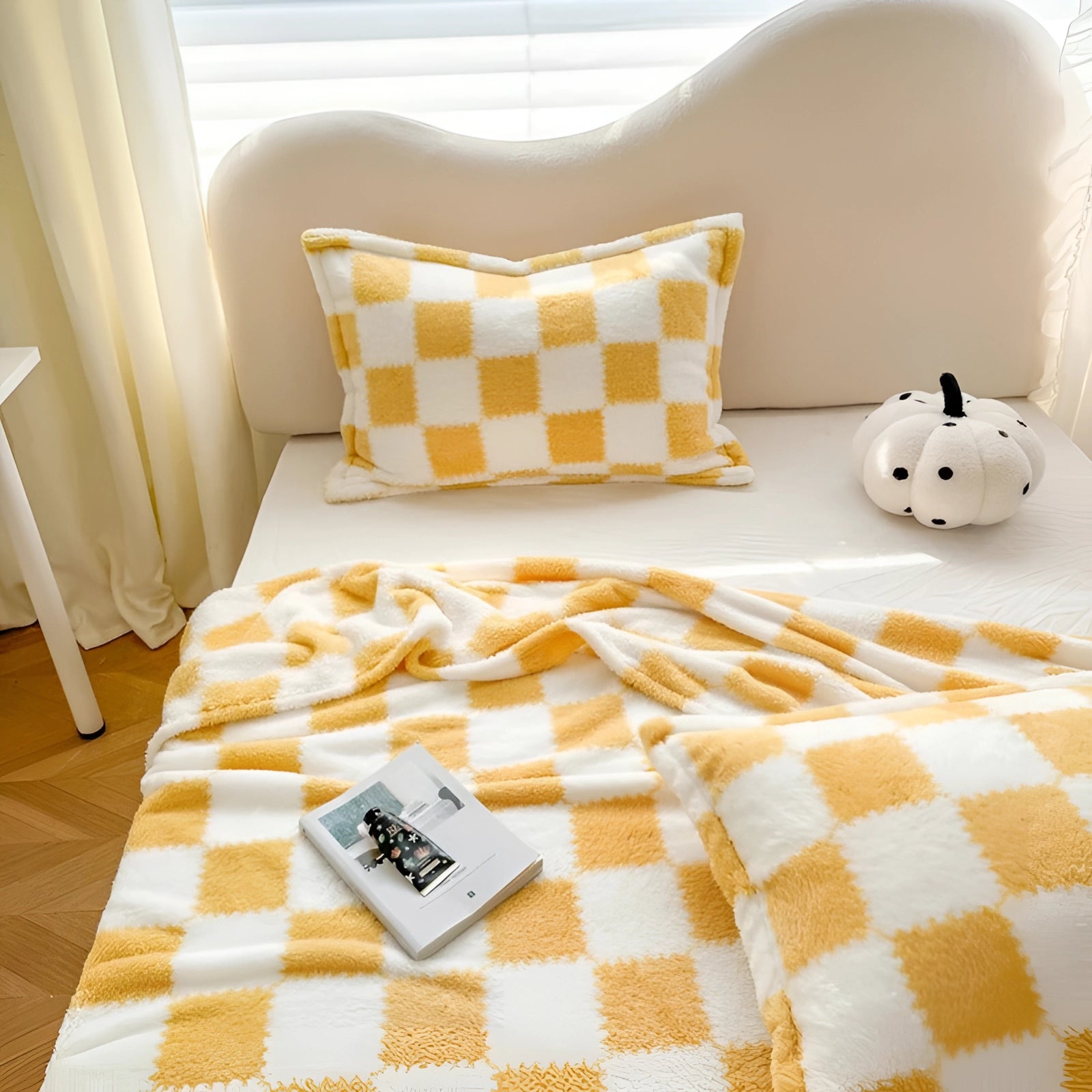 Yellow and white checkered bedding set featuring a gingham bedsheet and plaid duvet cover, displayed in a cozy bedroom setting with wooden flooring.