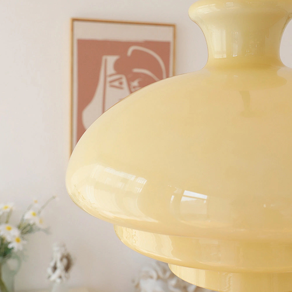 Modern Scandinavian minimalist yellow pendant light hanging from the ceiling.