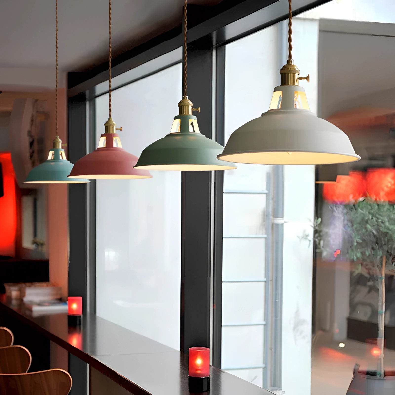 Yellow vintage dome pendant light with brass accents hanging in an industrial-style interior setting.