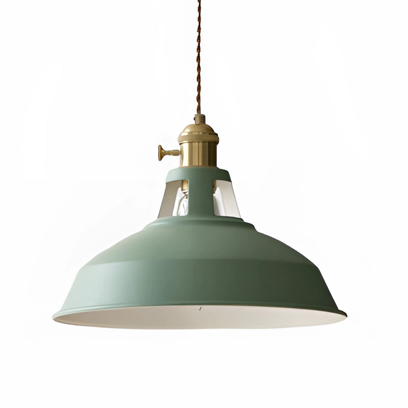 Yellow vintage dome pendant light with brass accents featuring an industrial design; hanging from the ceiling and showcasing a green tint, round dome shape, and metal construction.